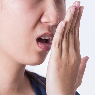 Woman smelling breath