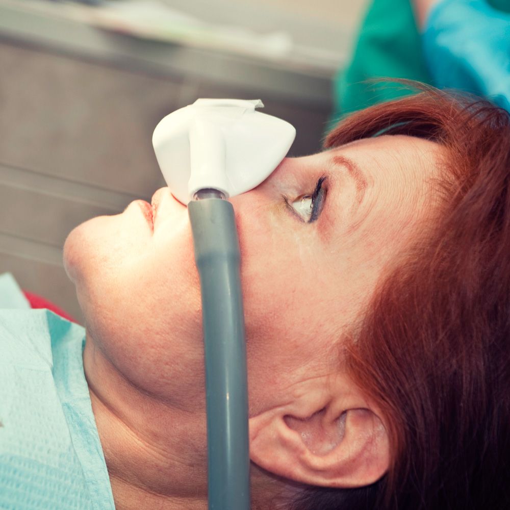 Woman receiving sedation through nasal mask